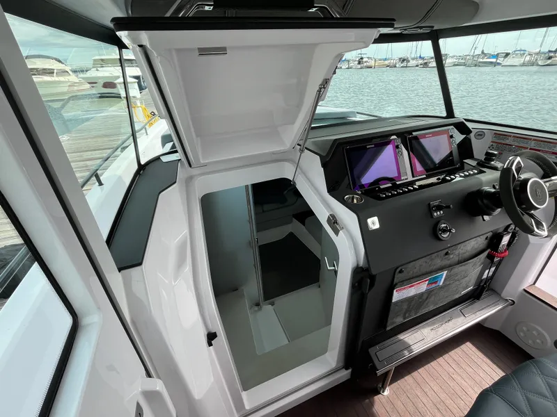Slide: The Image of The image shows the cockpit of a 2024 Axopar 37 XC Cross Cabin with modern instruments. - 17