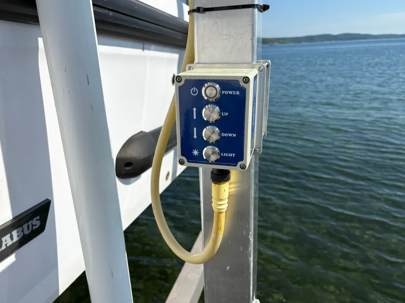 Slide: The Image of A control panel with buttons for Power, Up, Down, and Light, mounted on a boat. - 29