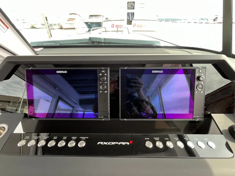 Slide: The Image of The image shows the dashboard of an Axopar 37 XC Cross Cabin with two Simrad screens. - 9