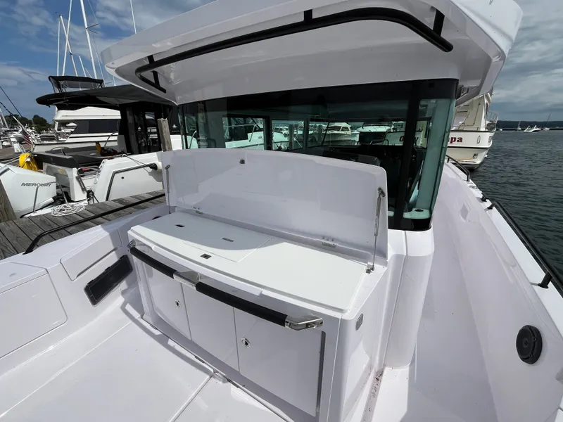 Slide: The Image of The image shows the stern of a 2024 Axopar 37 XC Cross Cabin with an outdoor kitchen. - 6