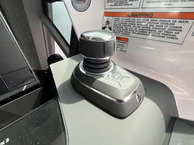 Slide: The Image of Joystick control on the console of a 2024 Axopar 37 XC Cross Cabin. - 10