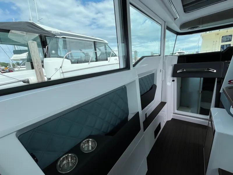Slide: The Image of Interior of a 2024 Axopar 37 XC Cross Cabin with modern seating and windows. - 15