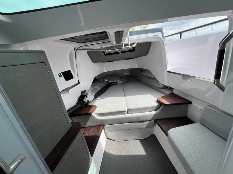 Slide: The Image of The cabin of the 2024 Axopar 37 XC Cross Cabin features a modern, comfortable design with gray upholstery. - 21