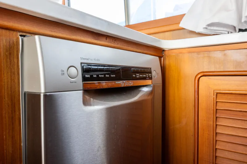 Slide: The Image of Built-in Bosch dishwasher in a 2006 North Pacific 52 yacht kitchen. - 24