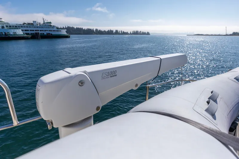 Slide: The Image of North Pacific 52 yacht with ES1000 crane on deck, 2006 model, near ferry on sunny water. - 45