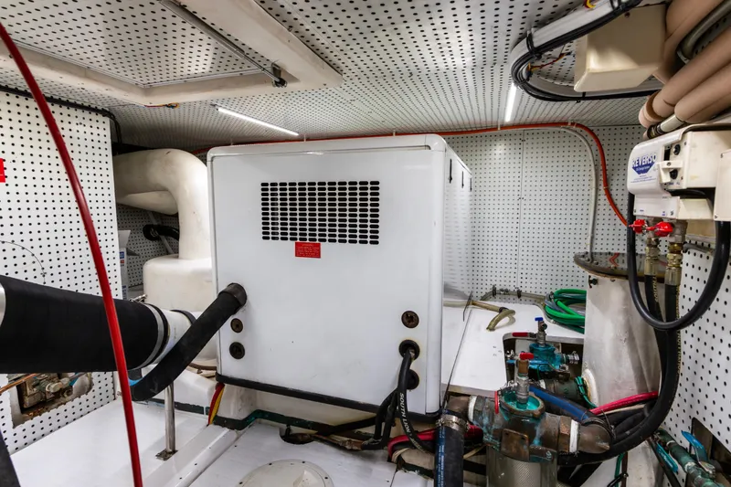 Slide: The Image of Engine room of a 2006 North Pacific 52 yacht, featuring mechanical equipment and piping. - 15