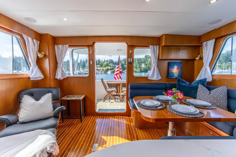 Slide: The Image of Luxurious interior of a 2006 North Pacific 52 yacht with elegant dining setup and scenic views. - 2