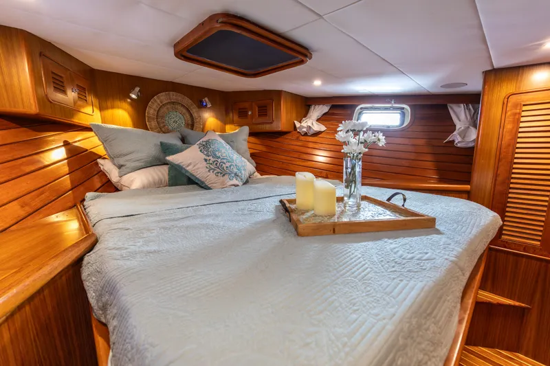 Slide: The Image of Luxurious cabin interior of a 2006 North Pacific 52 yacht with cozy bedding and decor. - 8