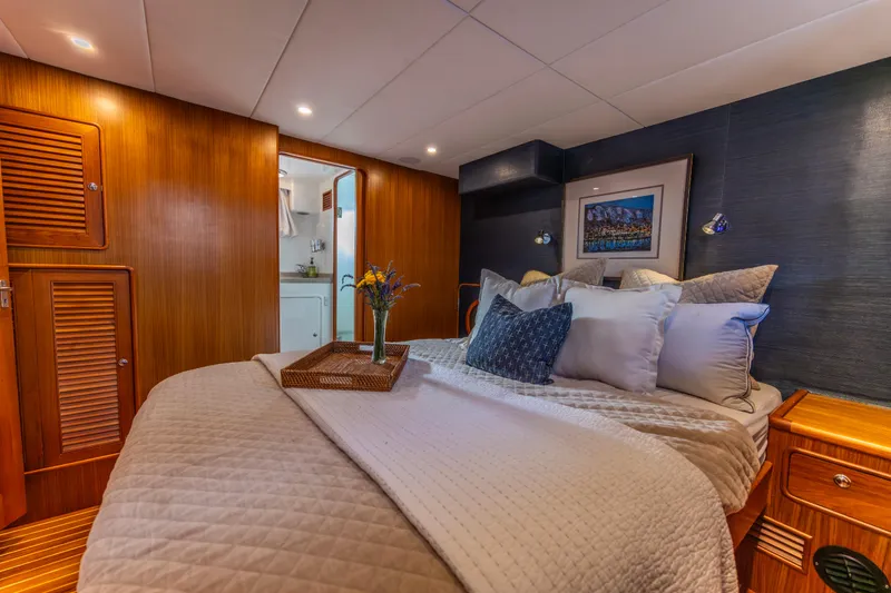 Slide: The Image of Luxurious cabin interior of 2006 North Pacific 52 yacht with cozy bedding and elegant decor. - 4