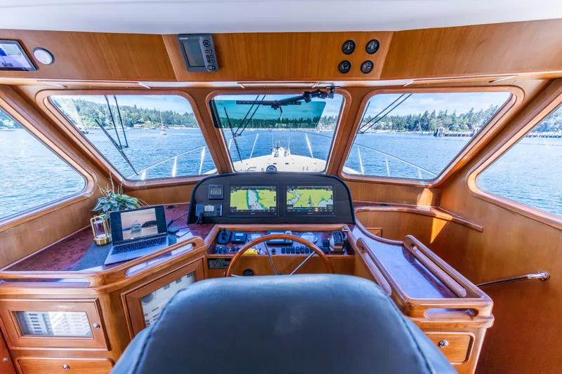 Slide: The Image of Helm of 2006 North Pacific 52 yacht with navigation screens and scenic ocean view. - 30