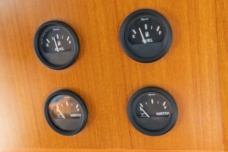 Slide: The Image of Fuel and water gauges on a 2006 North Pacific 52 boat dashboard. - 34