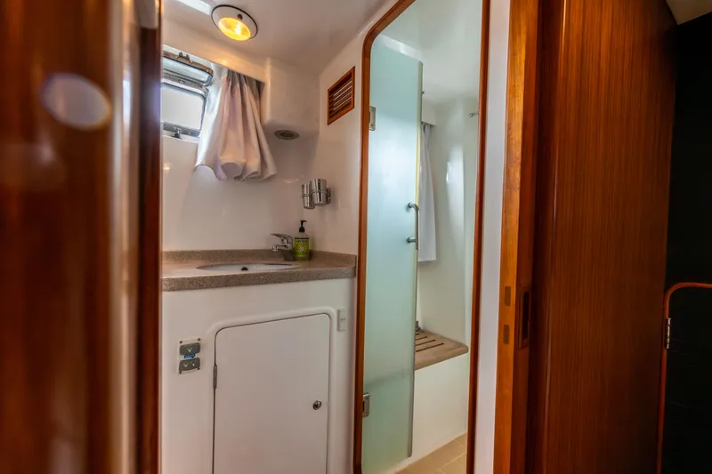 Slide: The Image of Bathroom interior of a 2006 North Pacific 52 yacht, featuring sink and shower. - 17