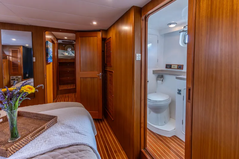 Slide: The Image of Luxurious 2006 North Pacific 52 yacht interior with cozy bedroom and modern bathroom. - 6