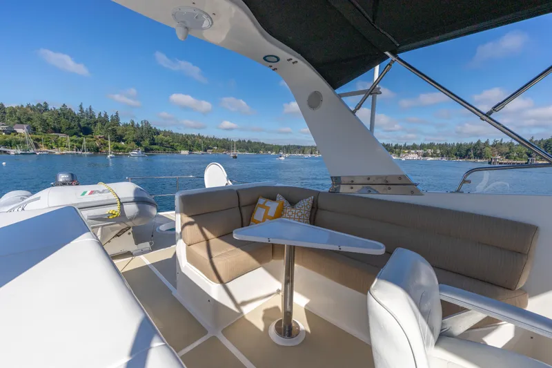 Slide: The Image of Luxurious seating area on a 2006 North Pacific 52 yacht, overlooking scenic waterfront. - 43