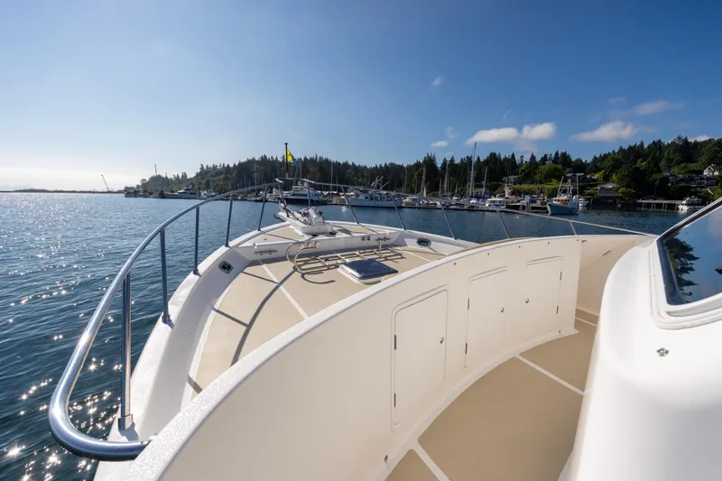 Slide: The Image of 2006 North Pacific 52 yacht deck with scenic harbor view under clear blue sky. - 40