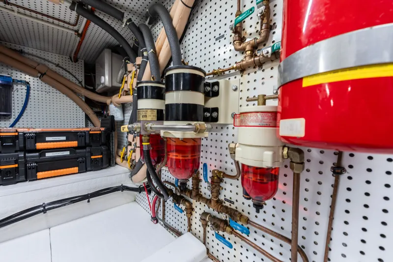 Slide: The Image of Engine room of a 2006 North Pacific 52 yacht, featuring fuel filters and storage boxes. - 16