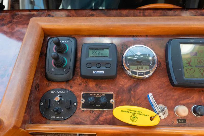 Slide: The Image of Control panel of a 2006 North Pacific 52 boat with various gauges and switches. - 32