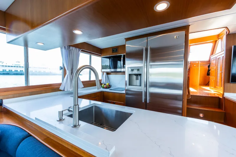 Slide: The Image of Luxurious kitchen interior of 2006 North Pacific 52 yacht with modern appliances and sleek design. - 23