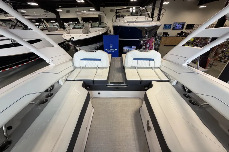 Slide: The Image of 2021 Regal LS4 Surf boat interior with luxurious seating in showroom. - 13