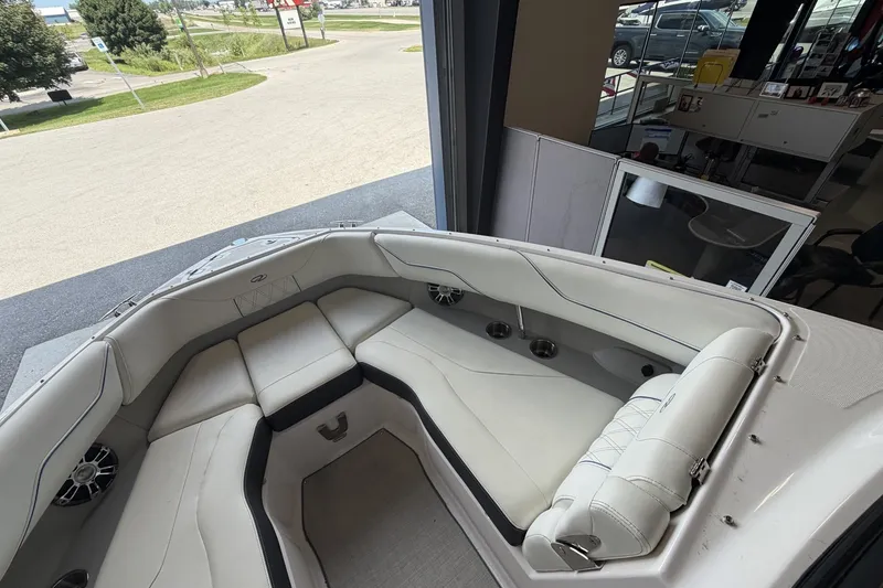 Slide: The Image of 2021 Regal LS4 Surf boat interior with white seating and cup holders. - 20