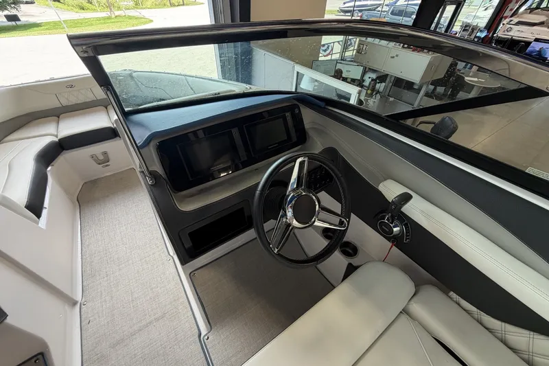 Slide: The Image of 2021 Regal LS4 Surf boat interior with steering wheel and dashboard controls. - 16