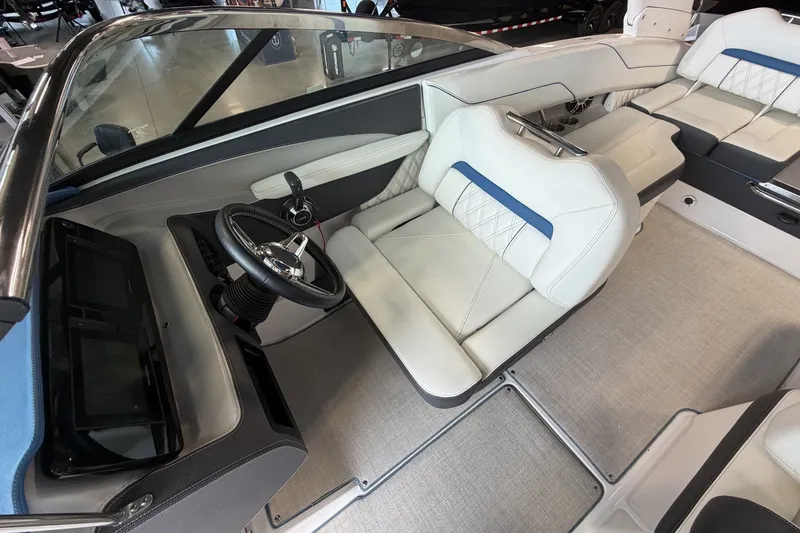 Slide: The Image of Interior of a 2021 Regal LS4 Surf boat featuring sleek seating and modern controls. - 17