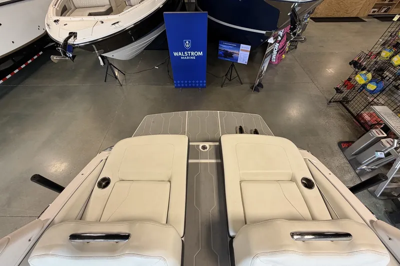 Slide: The Image of 2021 Regal LS4 Surf boat interior with beige seating at Walstrom Marine showroom. - 9