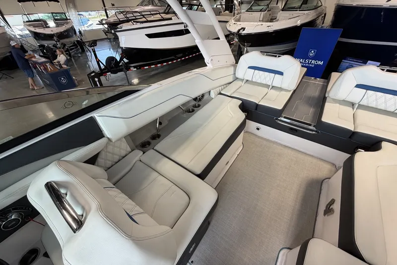 Slide: The Image of 2021 Regal LS4 Surf boat interior with luxurious white seating in showroom. - 12
