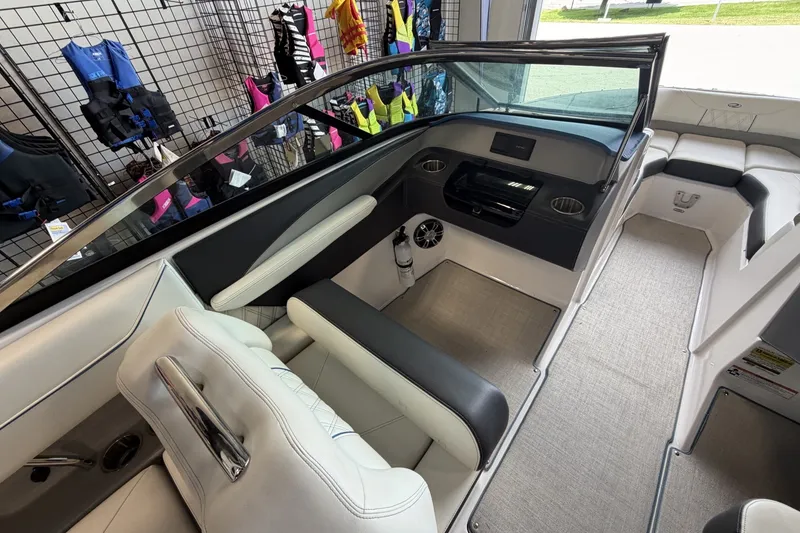 Slide: The Image of Interior of a 2021 Regal LS4 Surf boat with seating and dashboard. - 15