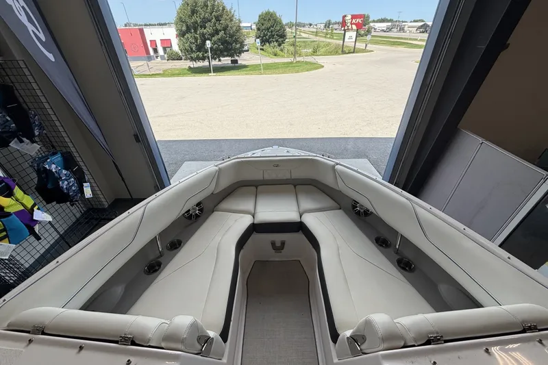 Slide: The Image of 2021 Regal LS4 Surf boat interior with plush seating and cup holders. - 19