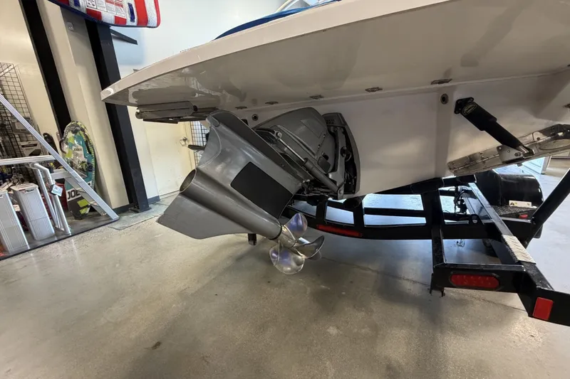 Slide: The Image of 2021 Regal LS4 Surf boat on trailer, showcasing propeller and stern details. - 4