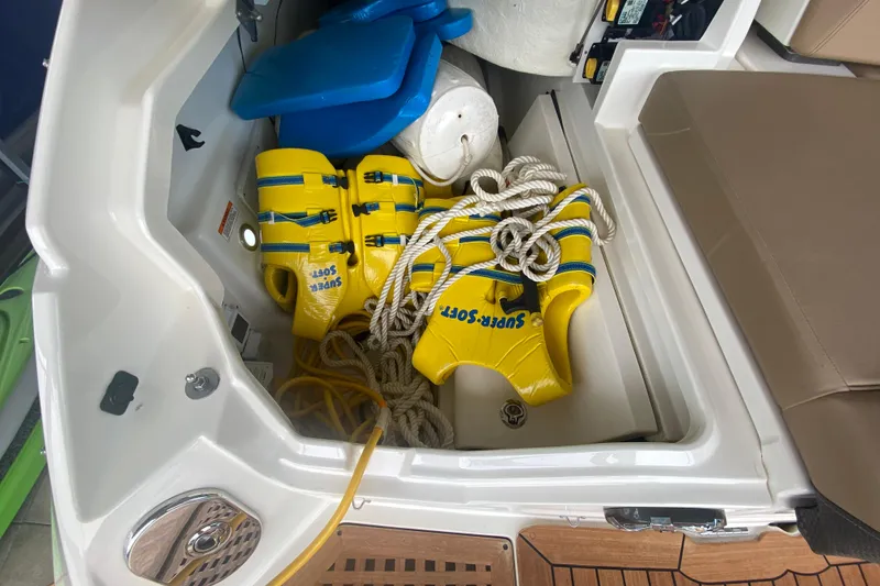 Slide: The Image of Storage compartment of 2019 Sea Ray SLX 400 with life jackets and ropes. - 14