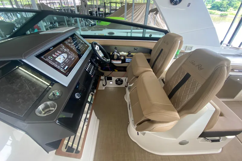 Slide: The Image of 2019 Sea Ray SLX 400 helm with dual leather seats and advanced navigation display. - 25