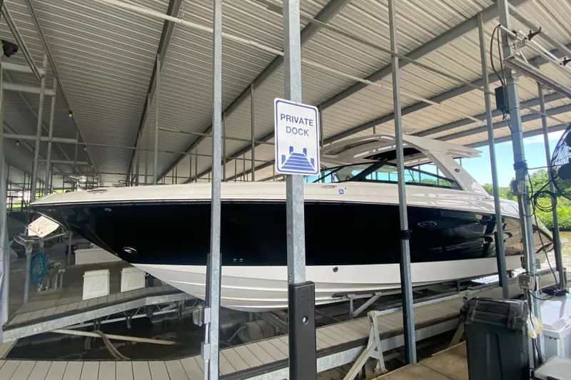 Slide: The Image of 2019 Sea Ray SLX 400 docked at a private marina under a covered structure. - 7