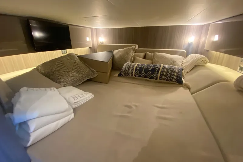 Slide: The Image of Luxurious cabin interior of 2019 Sea Ray SLX 400 with cozy bedding and ambient lighting. - 38