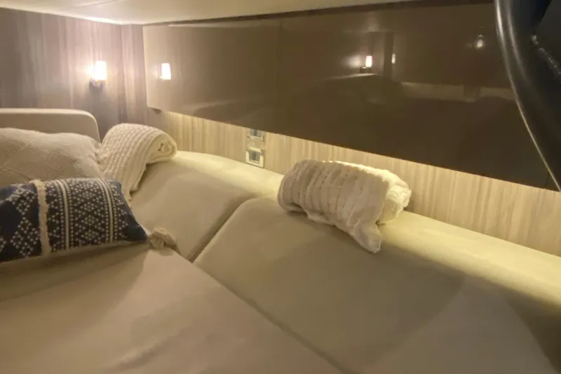 Slide: The Image of Luxurious interior cabin of 2019 Sea Ray SLX 400 with cozy bedding and ambient lighting. - 53