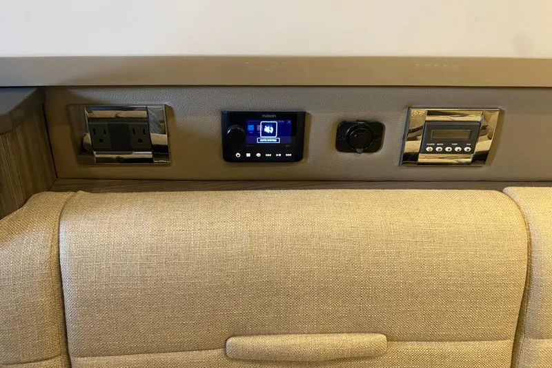 Slide: The Image of 2019 Sea Ray SLX 400 interior control panel with outlets and digital displays. - 36