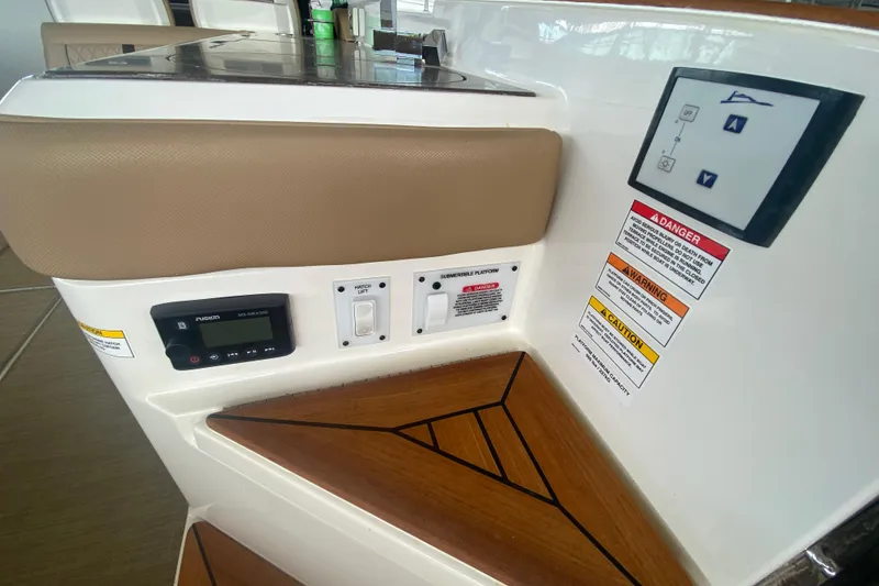 Slide: The Image of Control panel and warning labels on a 2019 Sea Ray SLX 400 boat interior. - 15