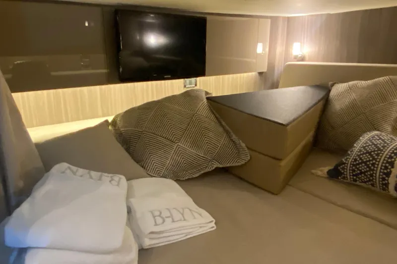 Slide: The Image of Luxurious interior cabin of 2019 Sea Ray SLX 400 with cozy bedding and TV. - 39
