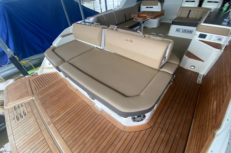 Slide: The Image of 2019 Sea Ray SLX 400 boat interior with tan seating and wooden deck. - 11