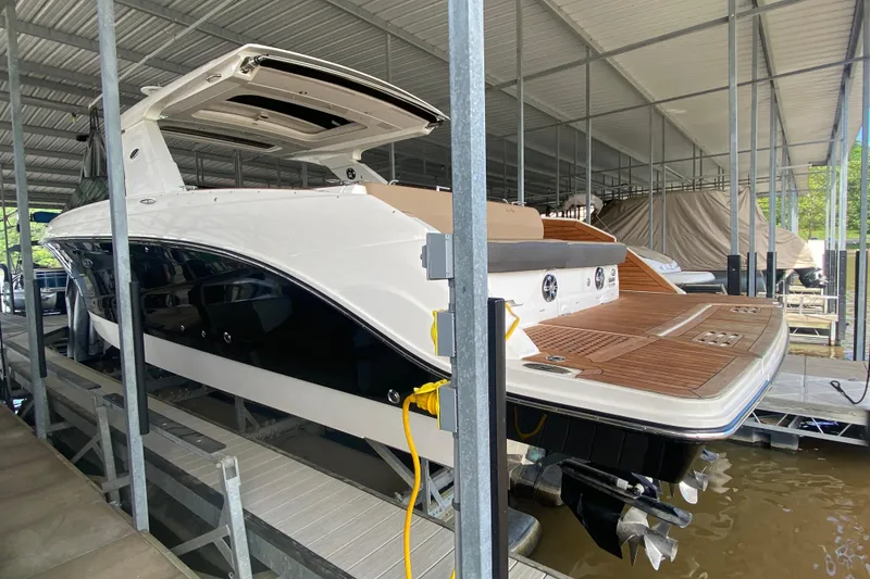 Slide: The Image of 2019 Sea Ray SLX 400 boat docked in a covered marina. - 3