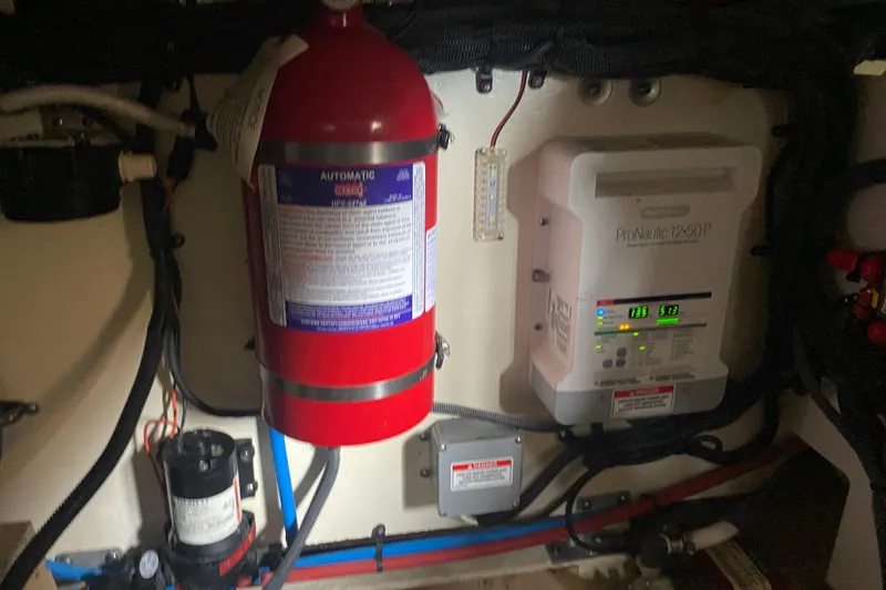 Slide: The Image of Engine room of 2019 Sea Ray SLX 400 with fire extinguisher and ProNautic charger. - 58