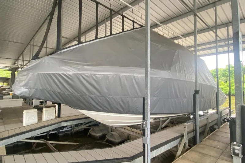 Slide: The Image of Covered 2019 Sea Ray SLX 400 boat in dock storage, sheltered by a metal roof. - 61