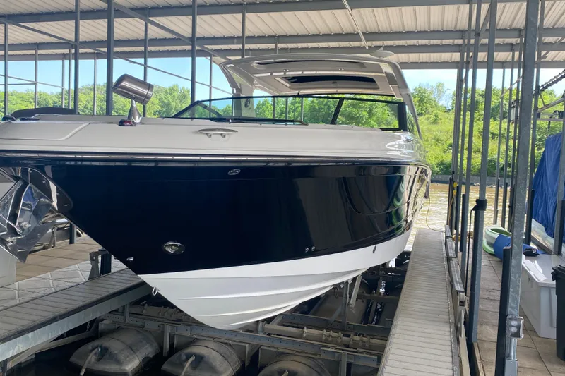 Slide: The Image of 2019 Sea Ray SLX 400 boat docked in a covered marina. - 8