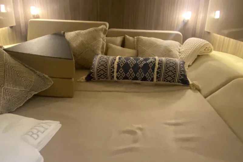 Slide: The Image of Luxurious cabin interior of 2019 Sea Ray SLX 400 with plush bedding and ambient lighting. - 54