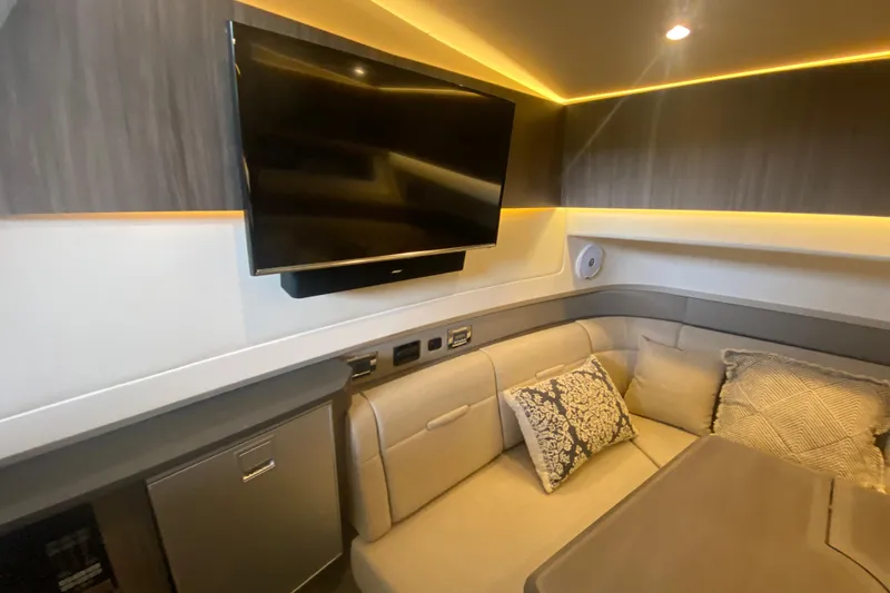 Slide: The Image of Luxurious interior of 2019 Sea Ray SLX 400 yacht with TV and plush seating. - 34