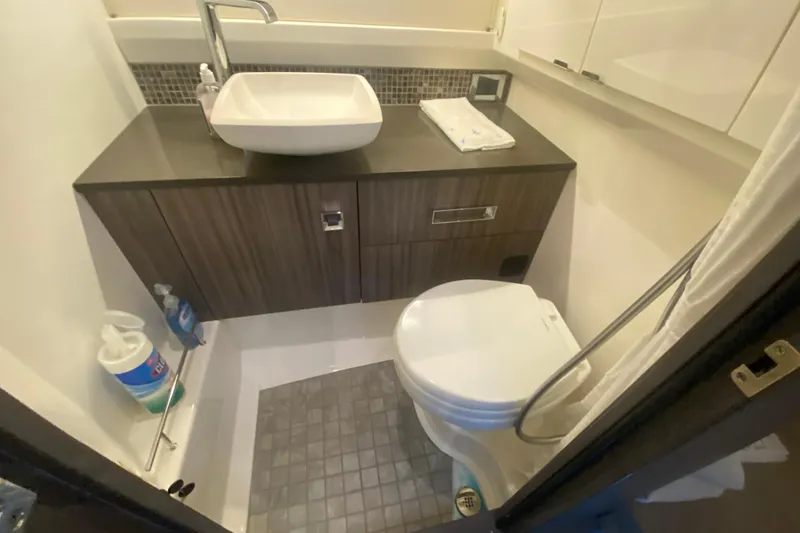 Slide: The Image of Compact bathroom in 2019 Sea Ray SLX 400 yacht with modern sink and toilet. - 40