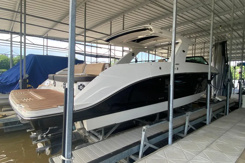 Slide: The Image of 2019 Sea Ray SLX 400 boat docked in a covered marina. - 5