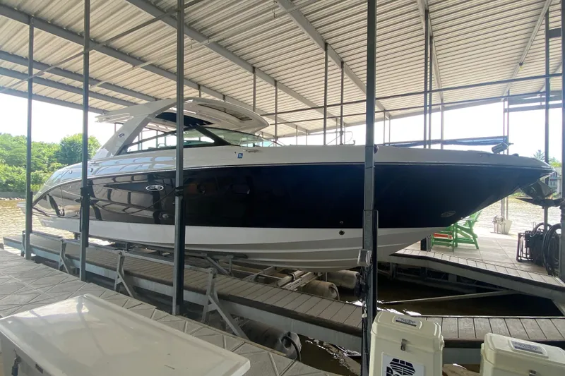 Slide: The Image of 2019 Sea Ray SLX 400 boat docked under a covered marina. - 9