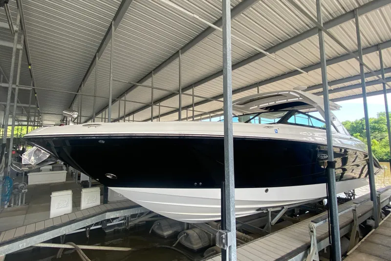 Slide: The Image of 2019 Sea Ray SLX 400 boat docked in a covered marina. - 6